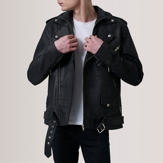 Person wearing a black leather jacket on a plain background