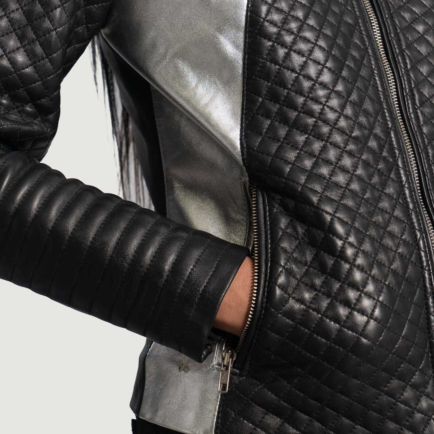 Detail of the luxurious quilted viscose lining inside the black biker jacket.
