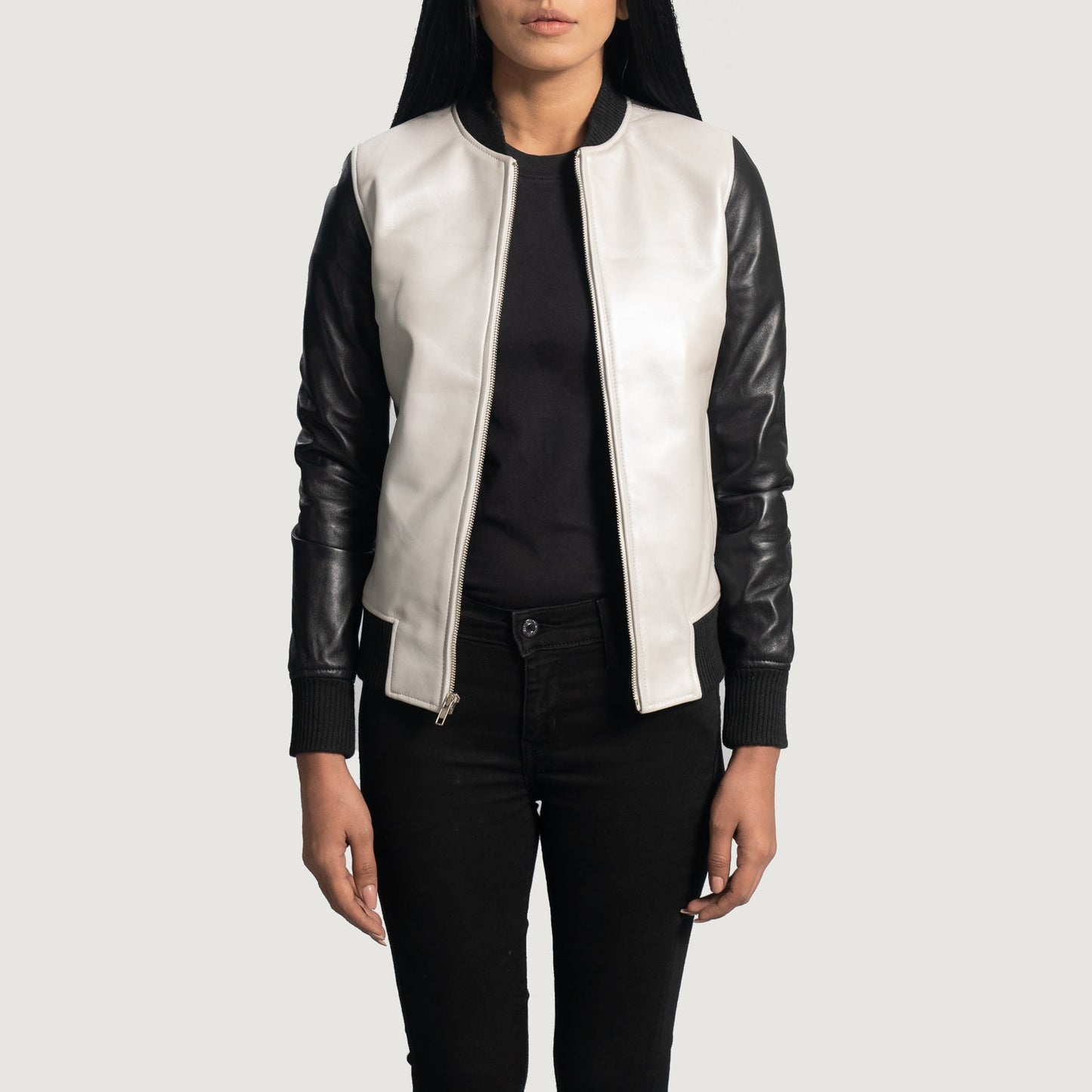 Three-quarter view of the silver and black leather varsity bomber jacket, highlighting its athletic silhouette and sleek zipper closure.