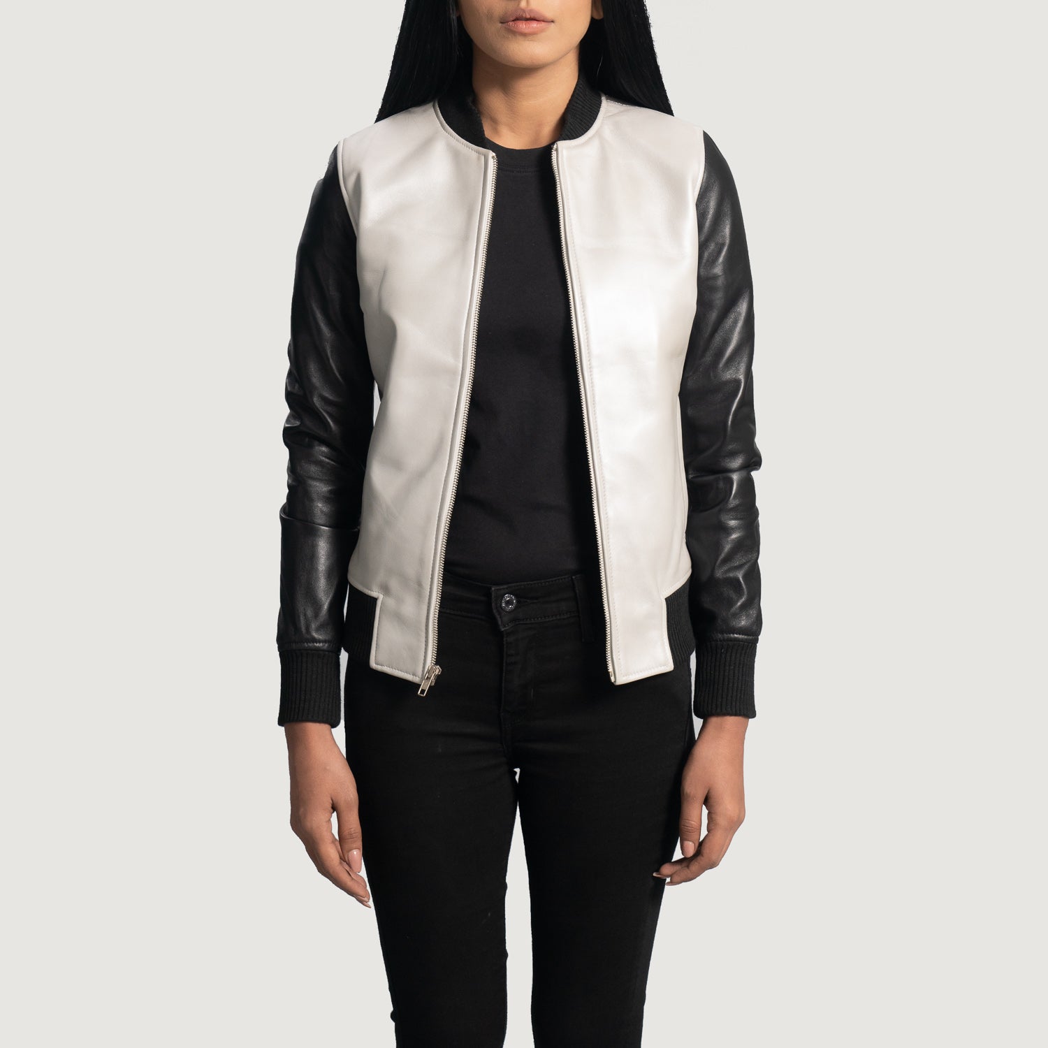 Three-quarter view of the silver and black leather varsity bomber jacket, highlighting its athletic silhouette and sleek zipper closure.