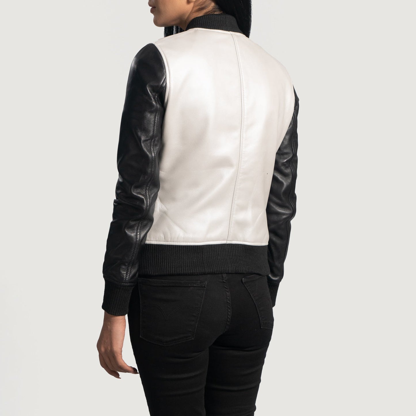 Close-up of the black ribbed knit cuff and a functional side pocket on the silver sheepskin bomber jacket.