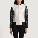 Front view of the Cole silver leather bomber jacket featuring black knit rib varsity collar, cuffs, and hem against a moody workshop background.