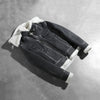Close up of the high neck collar design featuring belt buckle hardware.