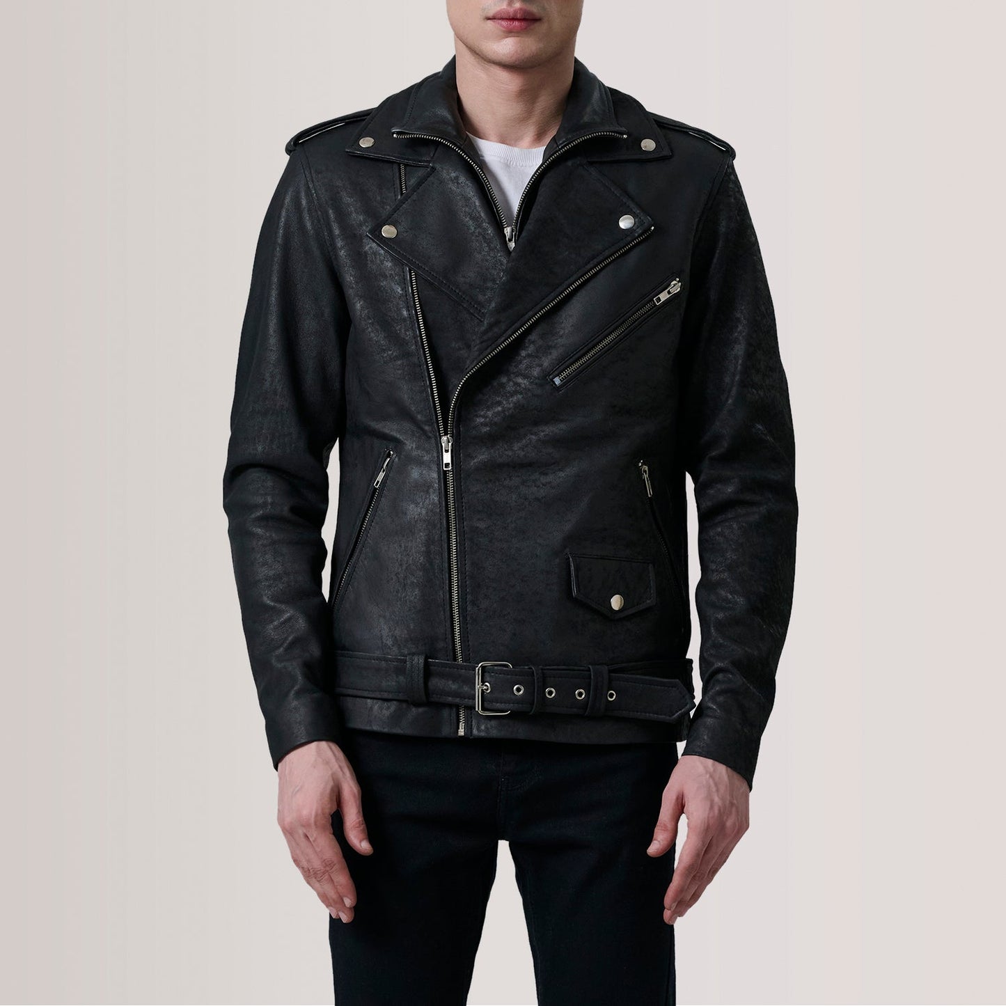 Black leather jacket worn by a person on a plain background