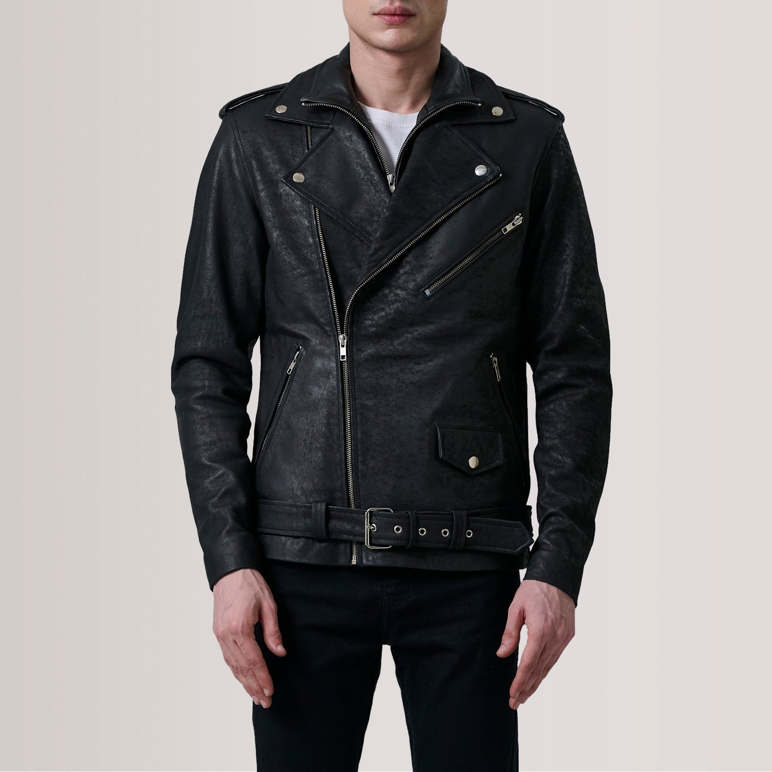 Black leather jacket worn by a person on a plain background