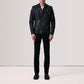 Person wearing a black leather jacket and pants on a plain background