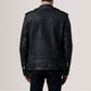 Black leather jacket worn by a person on a plain background