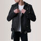 Person wearing a black leather jacket on a plain background