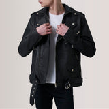 Person wearing a black leather jacket on a plain background