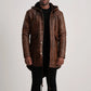 Man wearing a brown leather coat on a plain background