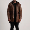 Man wearing a brown leather coat on a plain background