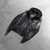 Interior view of the black jacket, revealing the premium quilted polyester lining and one of the two internal stash pockets.