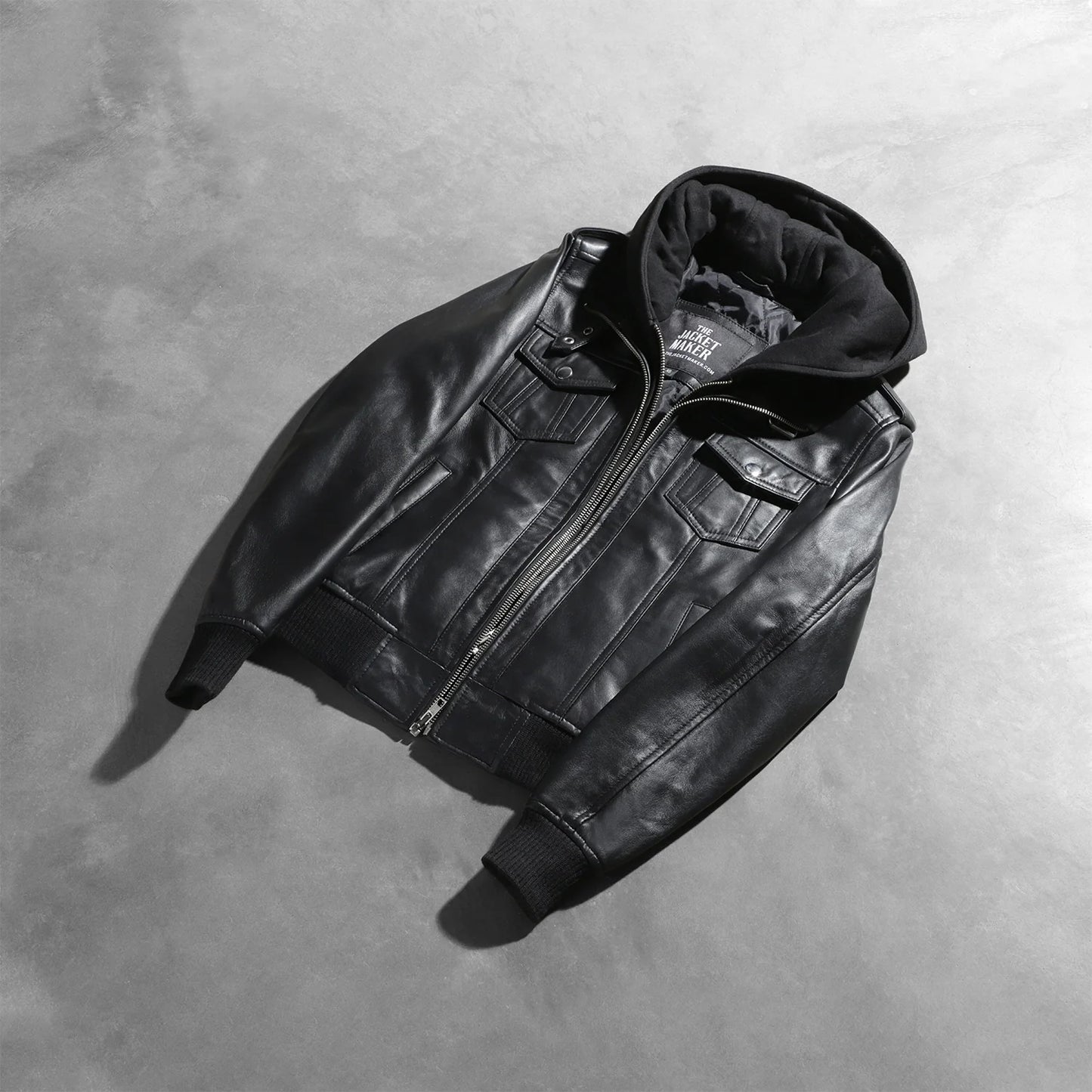 Interior view of the black jacket, revealing the premium quilted polyester lining and one of the two internal stash pockets.