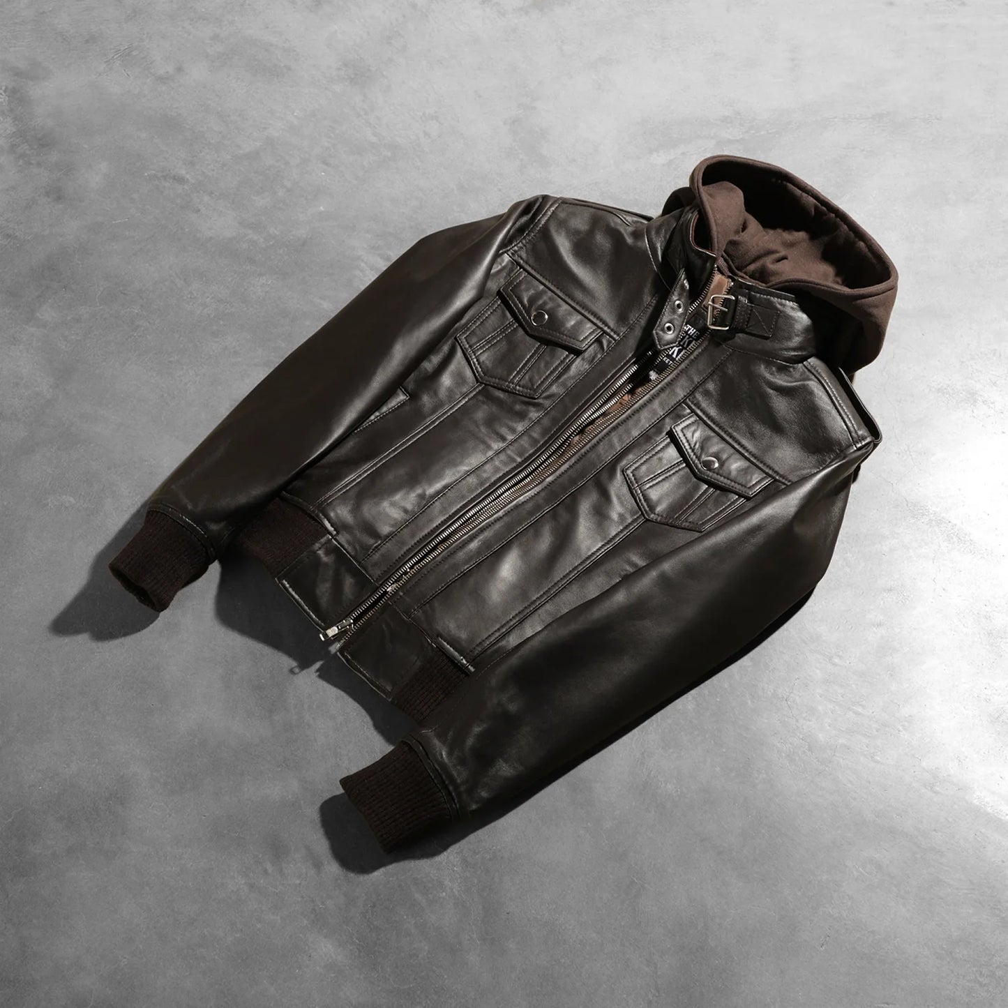 Detail of the quilted polyester lining inside the brown leather bomber.
