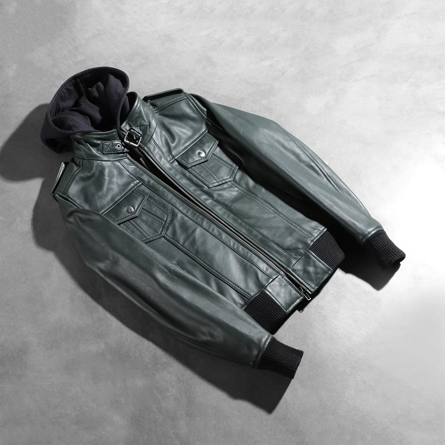Interior view of the green jacket, revealing the premium quilted polyester lining and one of the two internal stash pockets.