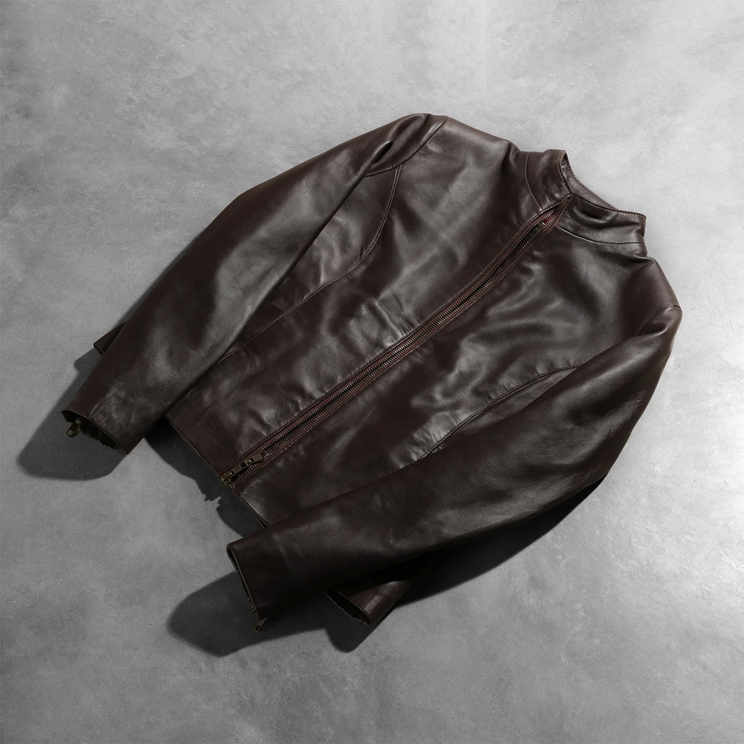 Detail of the secure interior storage pockets inside the maroon leather jacket.
