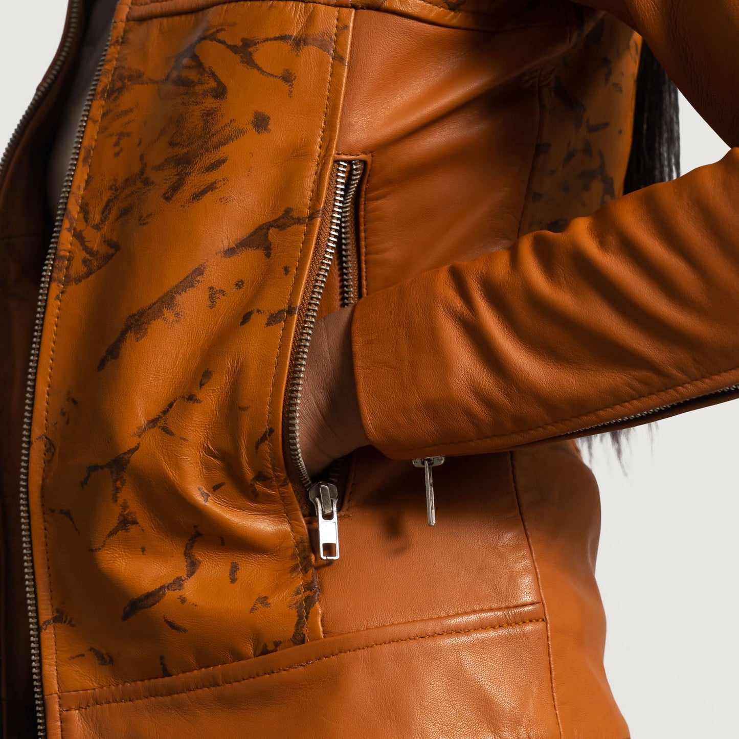 Detail of the luxurious quilted viscose lining inside the leather biker jacket.
