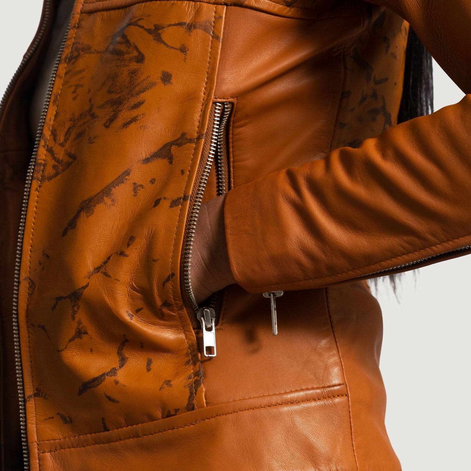 Detail of the luxurious quilted viscose lining inside the leather biker jacket.