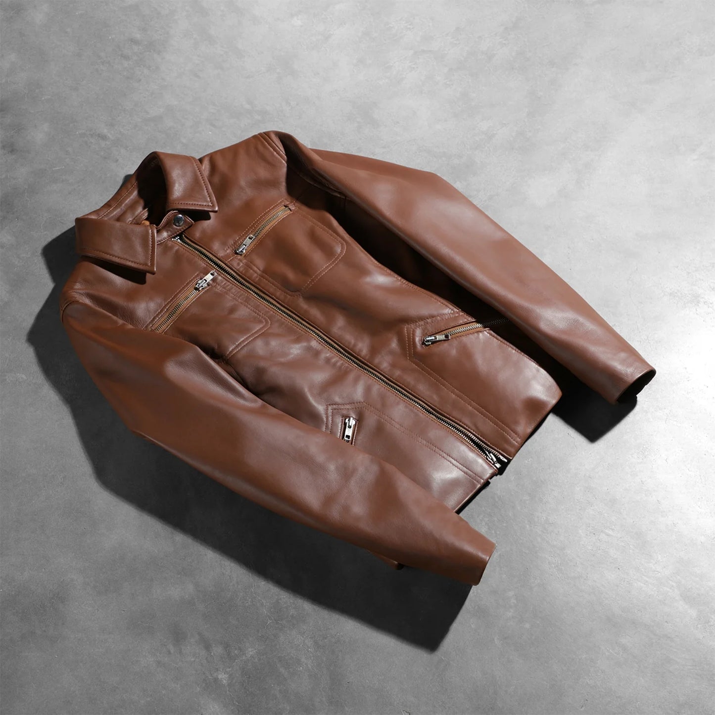 View of the four functional exterior pockets on the front of the brown leather.