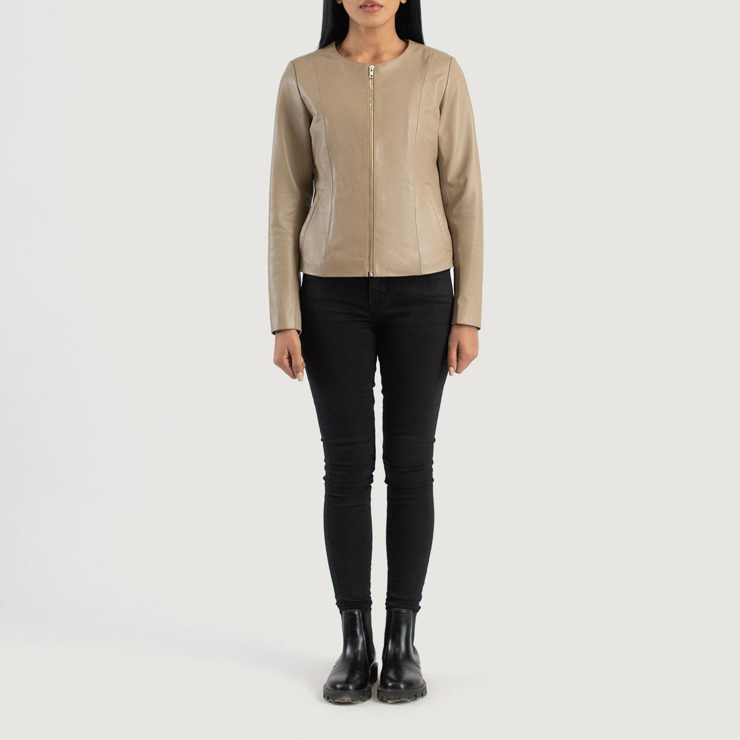 Three quarter profile view of the beige collarless jacket, highlighting its streamlined, minimalist silhouette and tailored fit.