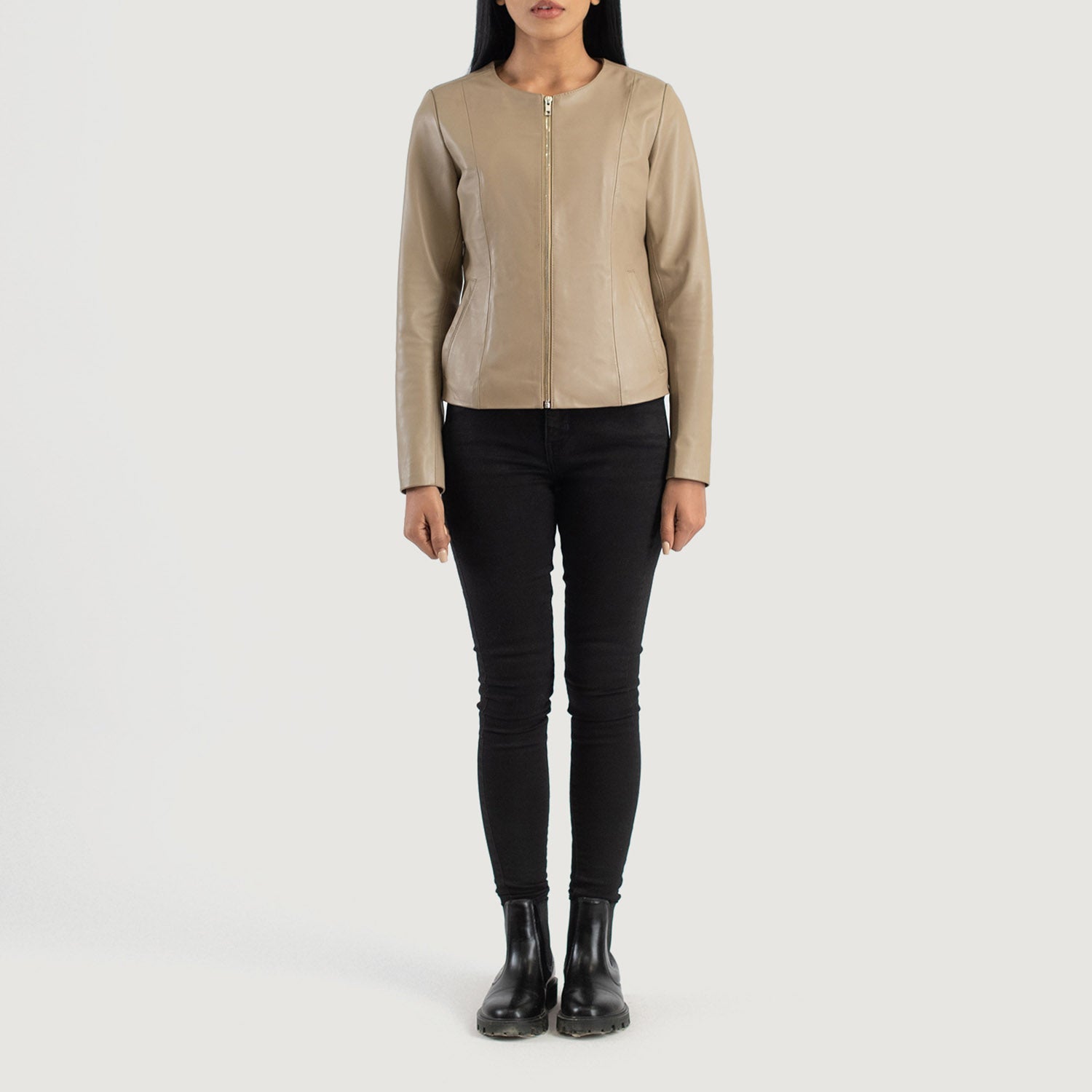 Three quarter profile view of the beige collarless jacket, highlighting its streamlined, minimalist silhouette and tailored fit.
