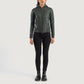 Three-quarter profile view of the green hooded leather jacket, highlighting its relaxed athletic silhouette and comfortable drape.