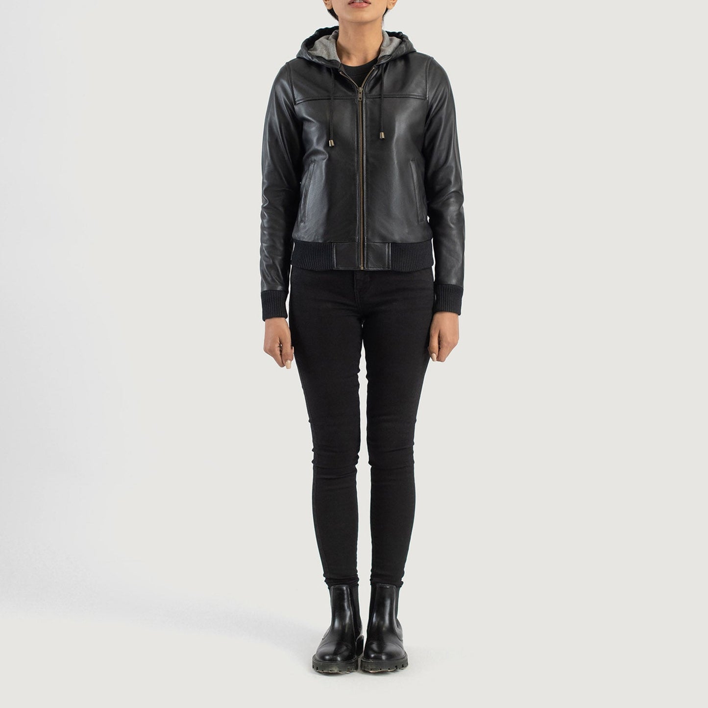 Three quarter profile view of the black hooded leather jacket, highlighting its relaxed athletic silhouette and comfortable fit.