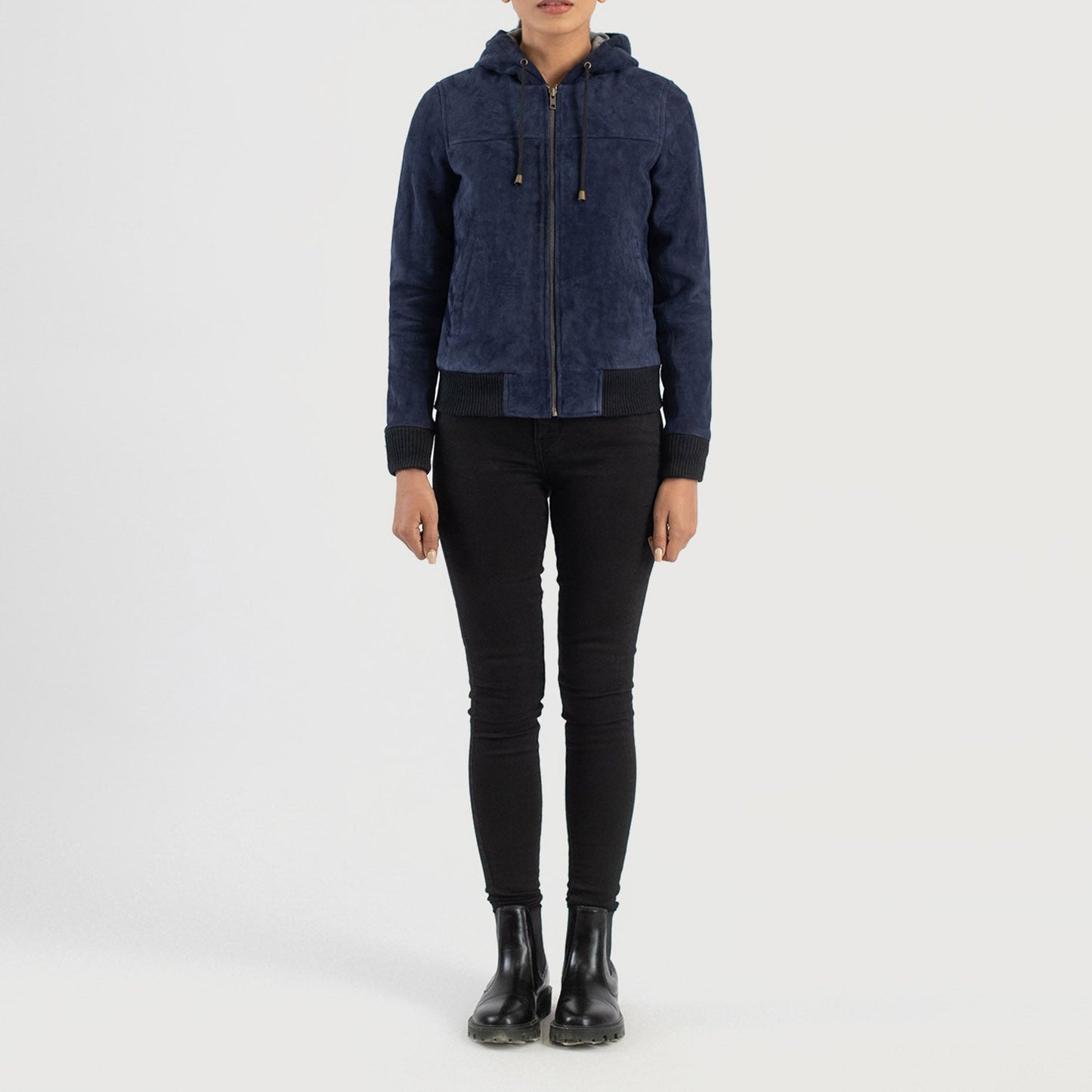 Three quarter profile view of the blue hooded suede jacket, highlighting its relaxed athletic fit and side pockets.
