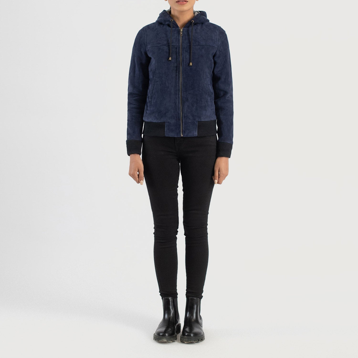 Three quarter profile view of the blue hooded suede jacket, highlighting its relaxed athletic fit and side pockets.