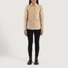 Three quarter profile view of the beige leather shirt jacket, emphasizing its sleek minimalist silhouette and lightweight look.