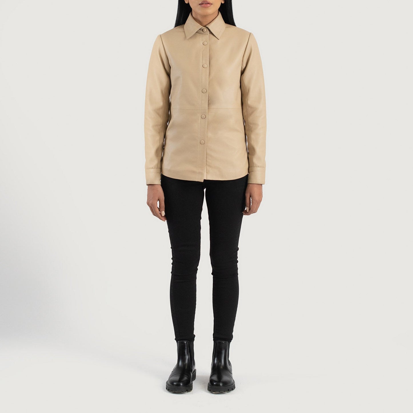 Three quarter profile view of the beige leather shirt jacket, emphasizing its sleek minimalist silhouette and lightweight look.