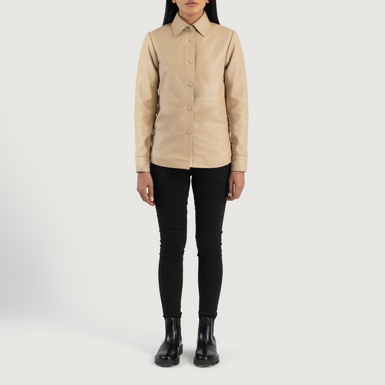 Three quarter profile view of the beige leather shirt jacket, emphasizing its sleek minimalist silhouette and lightweight look.