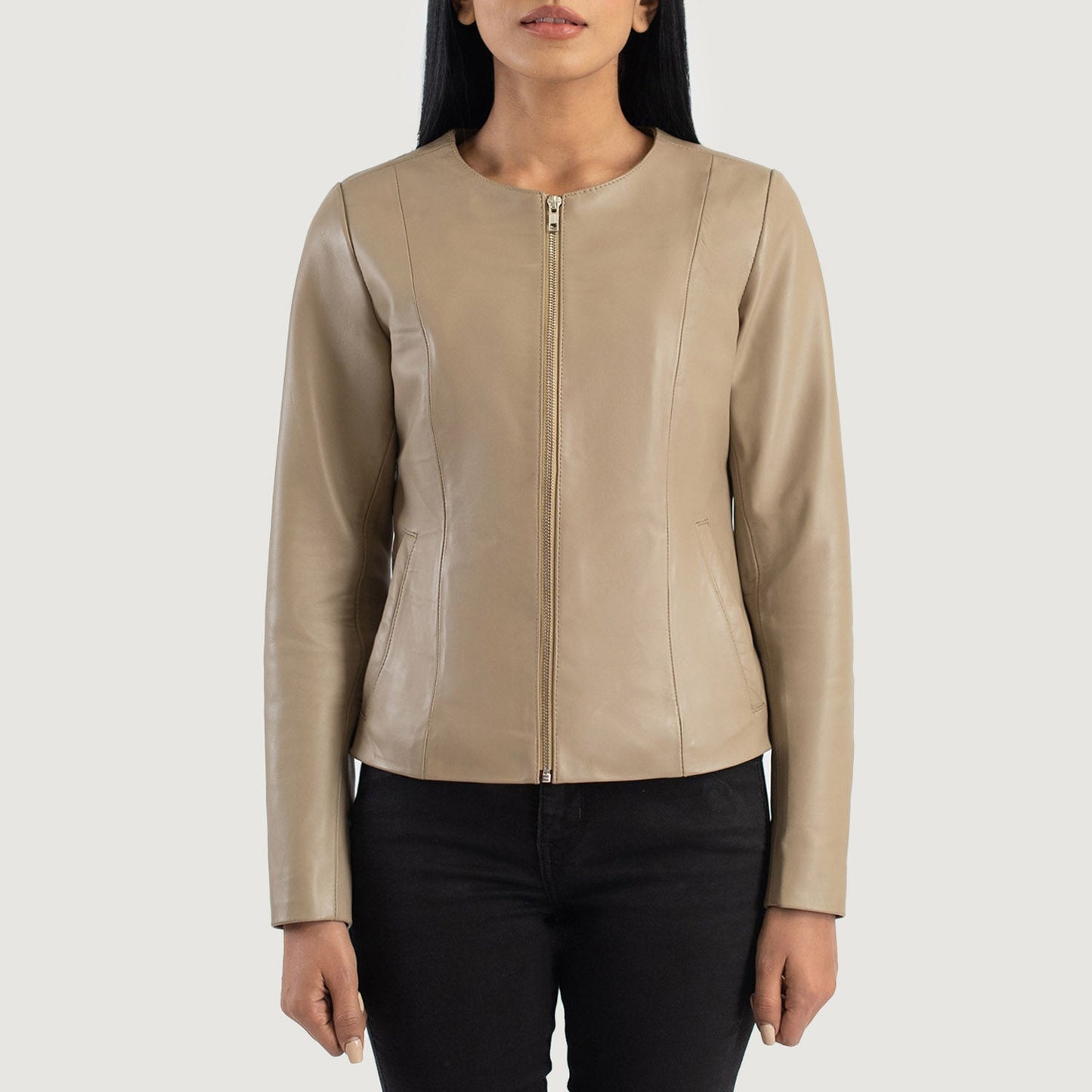Detailed shot of the clean, raw aesthetic of the collarless neckline and the high quality front zipper hardware.
