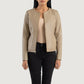 Front view of the Elixir beige leather jacket featuring a modern collarless neckline, central zipper closure, and open hem cuffs.