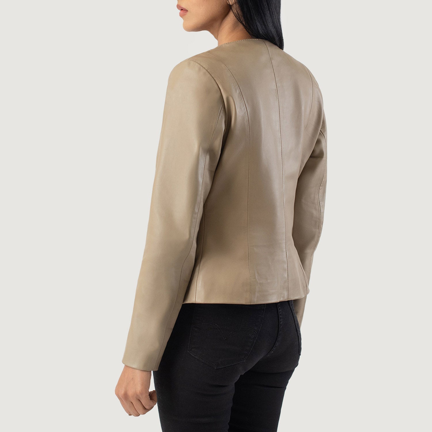 Close up of the sleek sleeve design featuring the classic unribbed open hem cuffs on the beige leather hide.