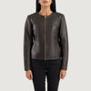 Detailed shot of the clean, raw aesthetic of the collarless neckline and the high quality front zipper hardware.