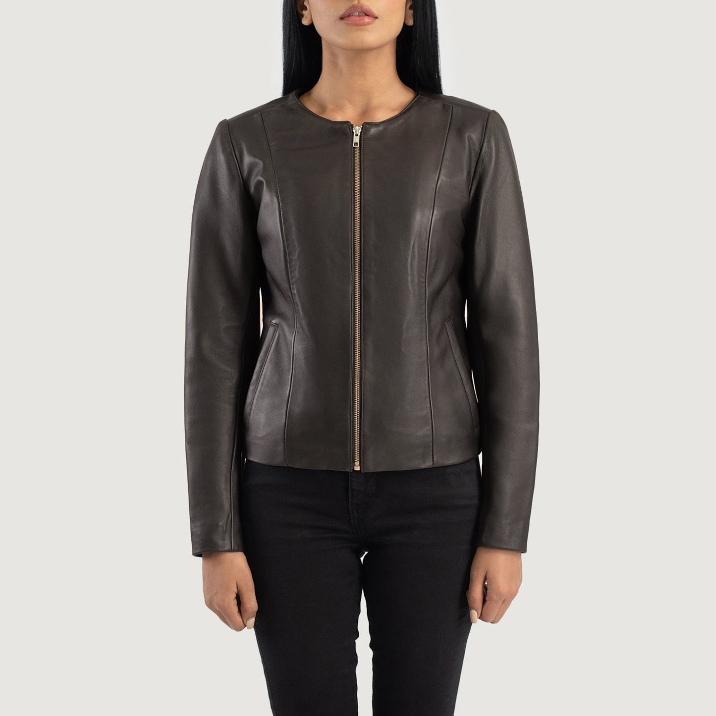 Detailed shot of the clean, raw aesthetic of the collarless neckline and the high quality front zipper hardware.