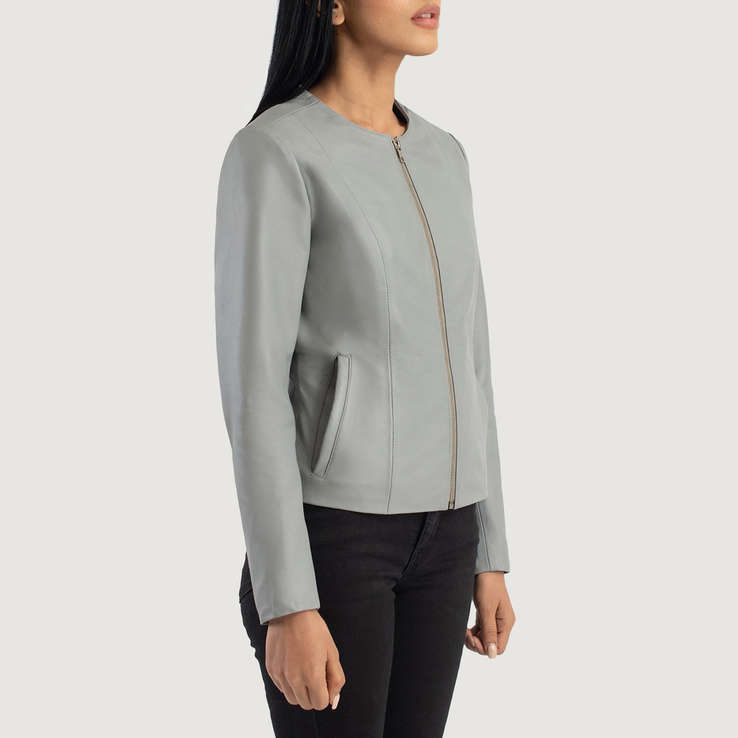 Three quarter profile view of the grey collarless jacket, highlighting its streamlined, minimalist silhouette and tailored fit.
