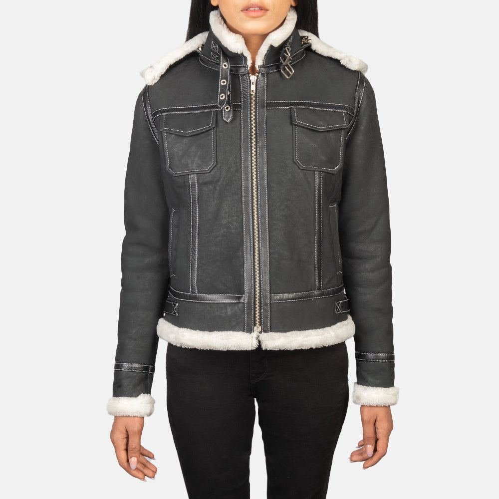 Close up of the four exterior pockets on the front of the black leather jacket.