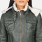Zoomed-in view of the side waist adjustment straps and one of the four functional front pockets on the green shearling jacket.