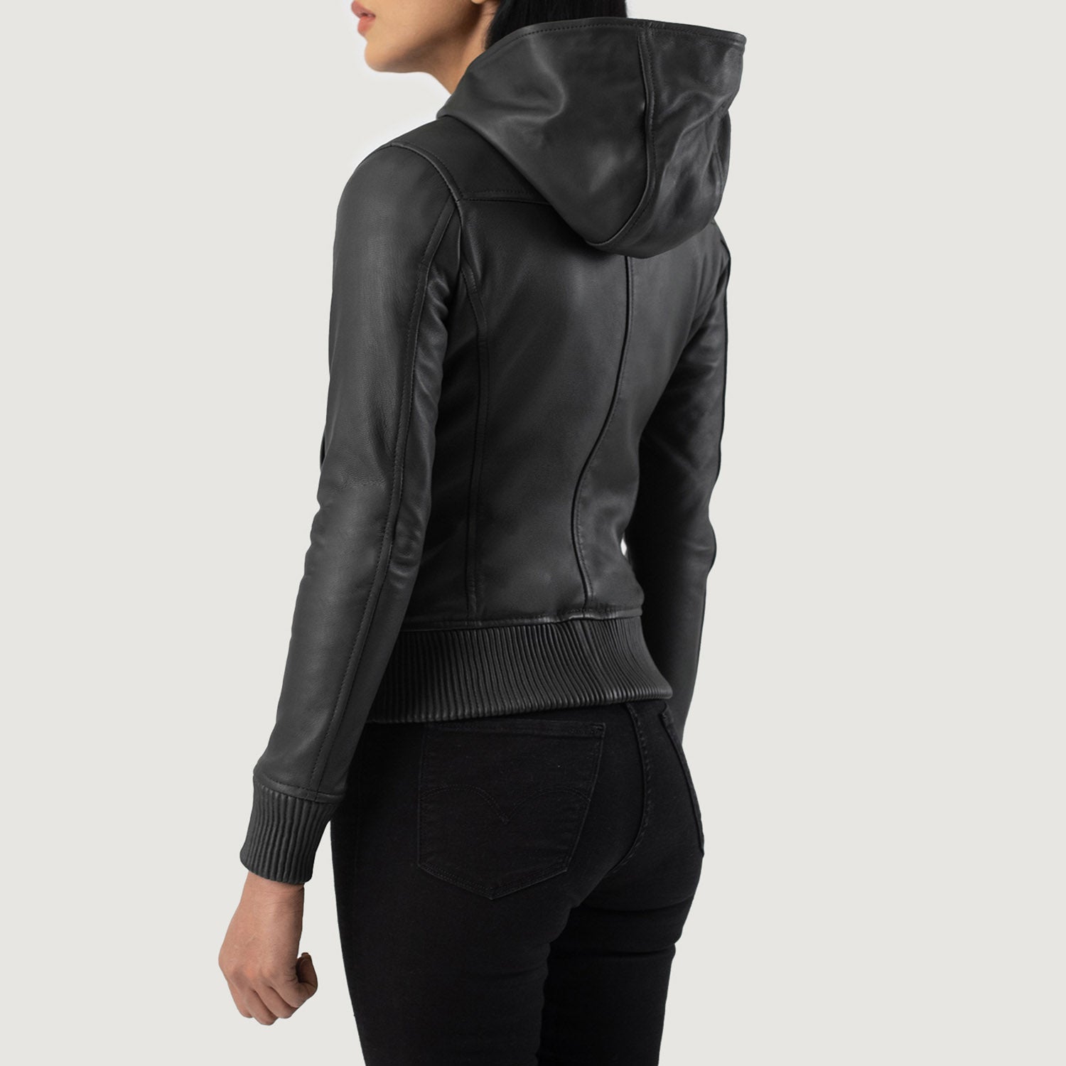 Detailed front view focusing on the asymmetric layout of the three functional outside pockets on the black leather bomber jacket.