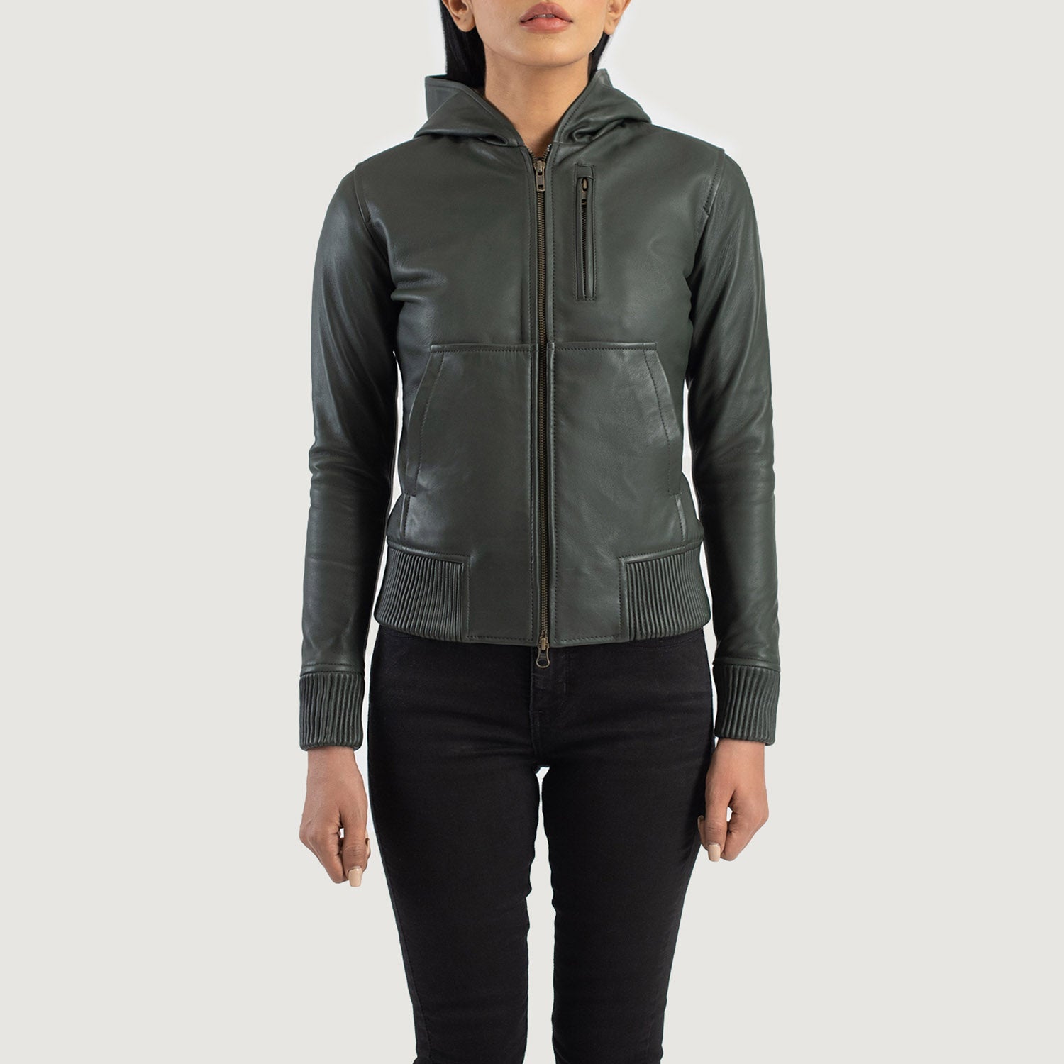 Detailed front view focusing on the layout of the three functional outside pockets on the green leather bomber jacket.
