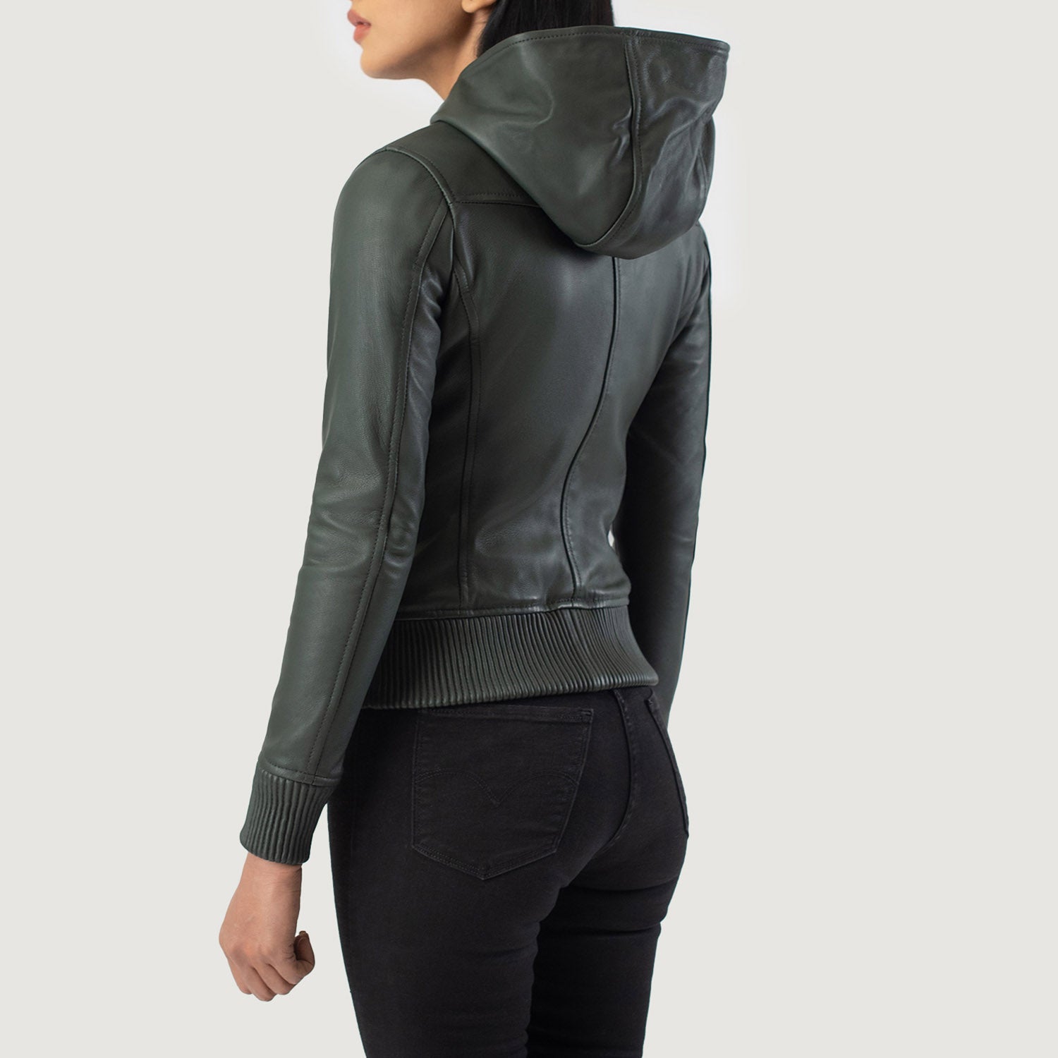 Close-up of the attached leather hood and high-quality front zipper closure on the green sheepskin jacket.