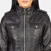 Zoomed in shot showing the texture contrast of the grey removable fabric hood attached to the sleek black leather shell.