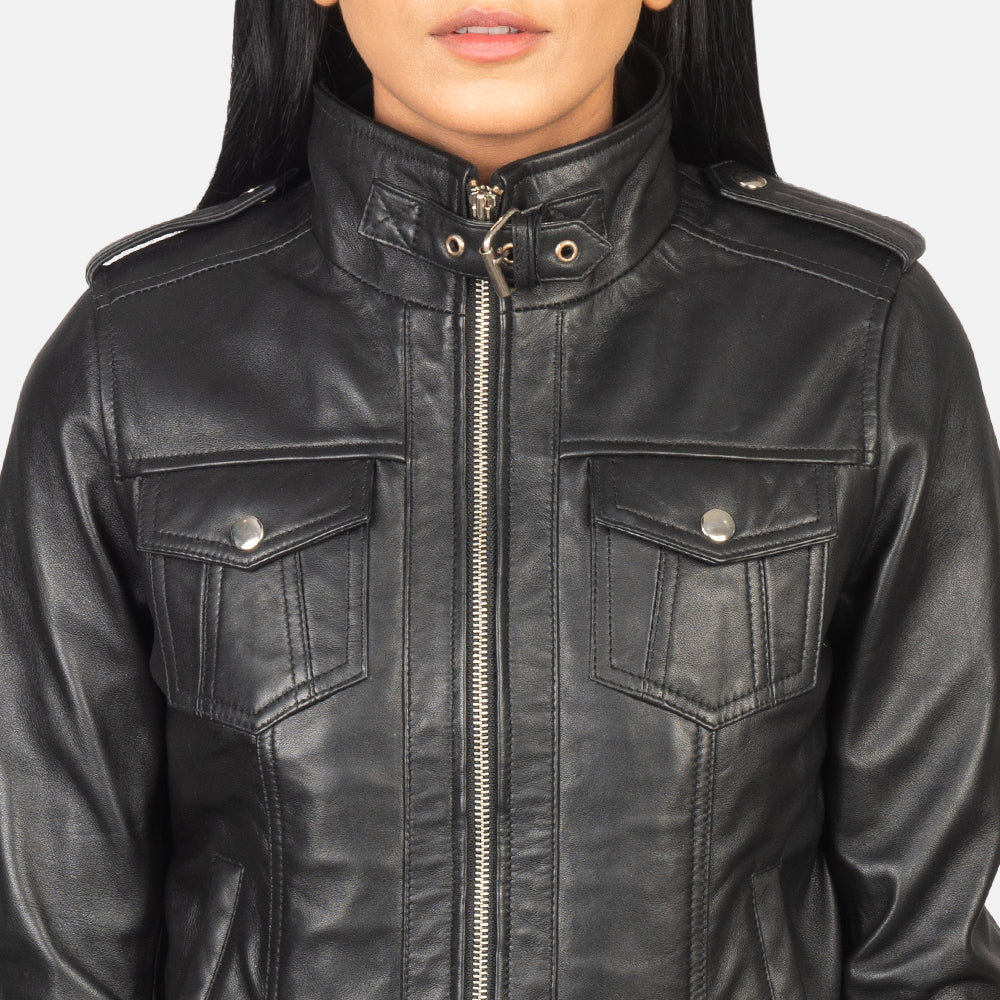 Zoomed in shot showing the texture contrast of the grey removable fabric hood attached to the sleek black leather shell.