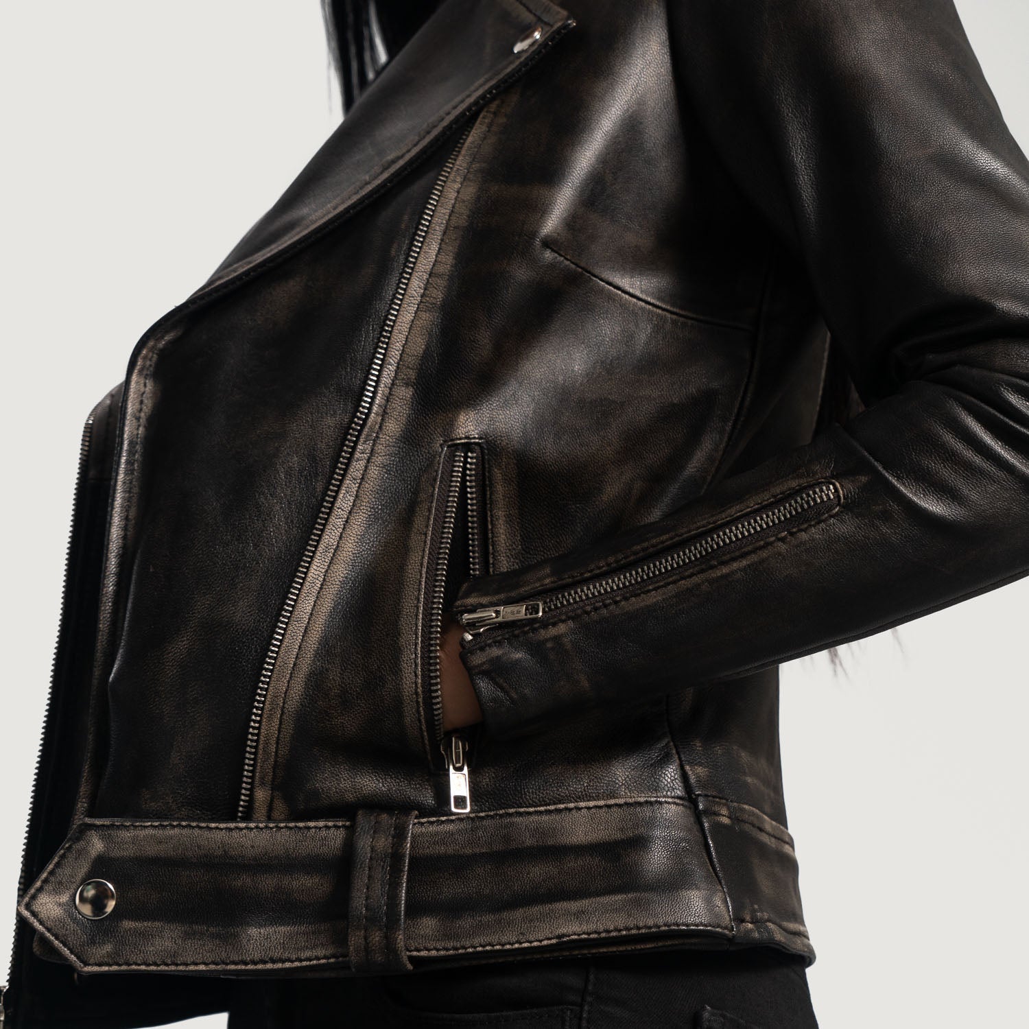 Close up of the rugged rub off goatskin leather texture in distressed brown.
