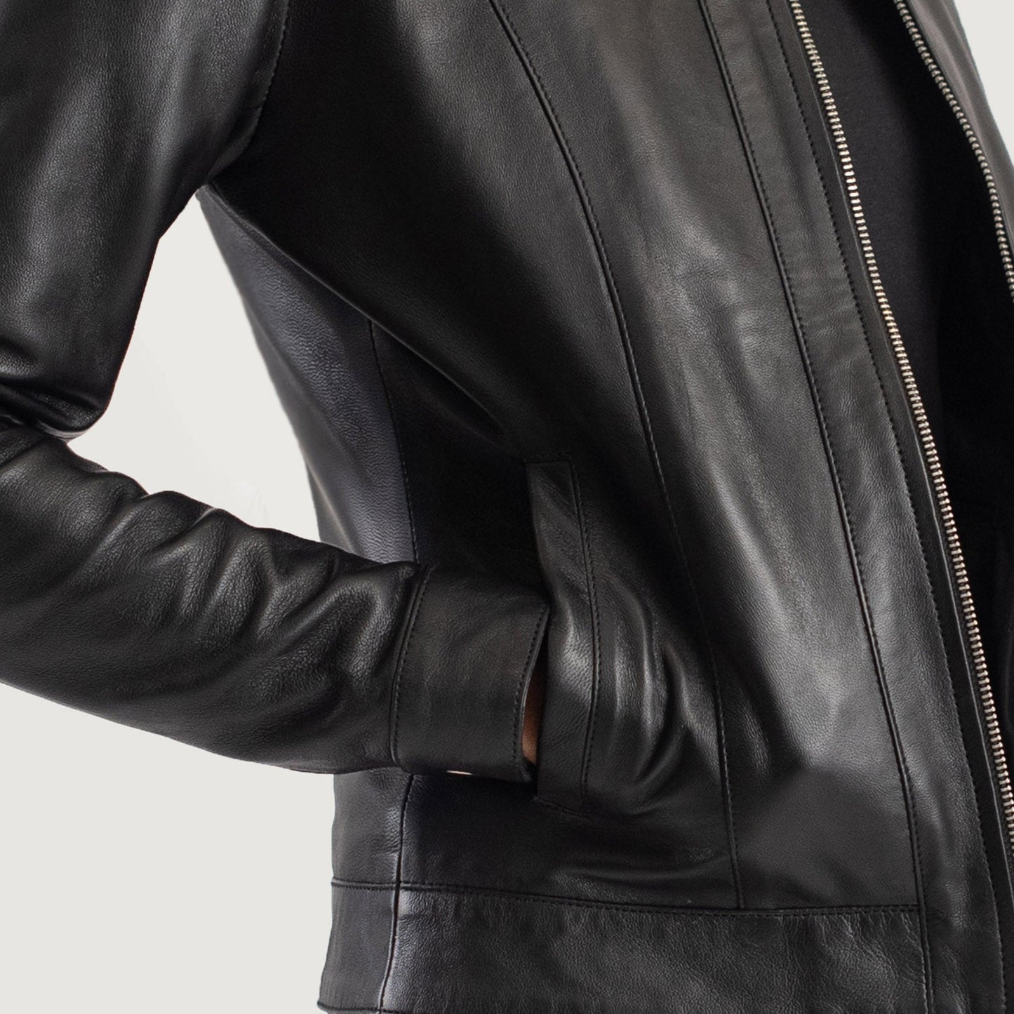 Close up of the interior storage pockets inside the leather bomber style jacket.