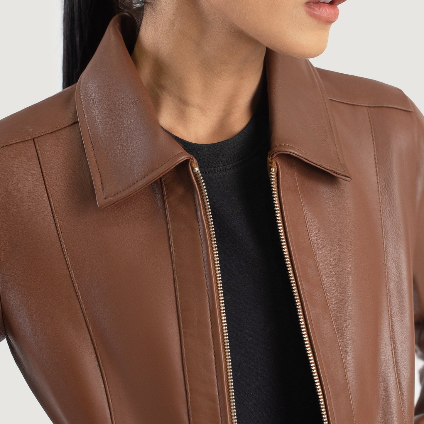 Cinematic side angle view of the brown classic collar leather jacket, capturing the subtle sheen of the hide under warm, natural lighting.