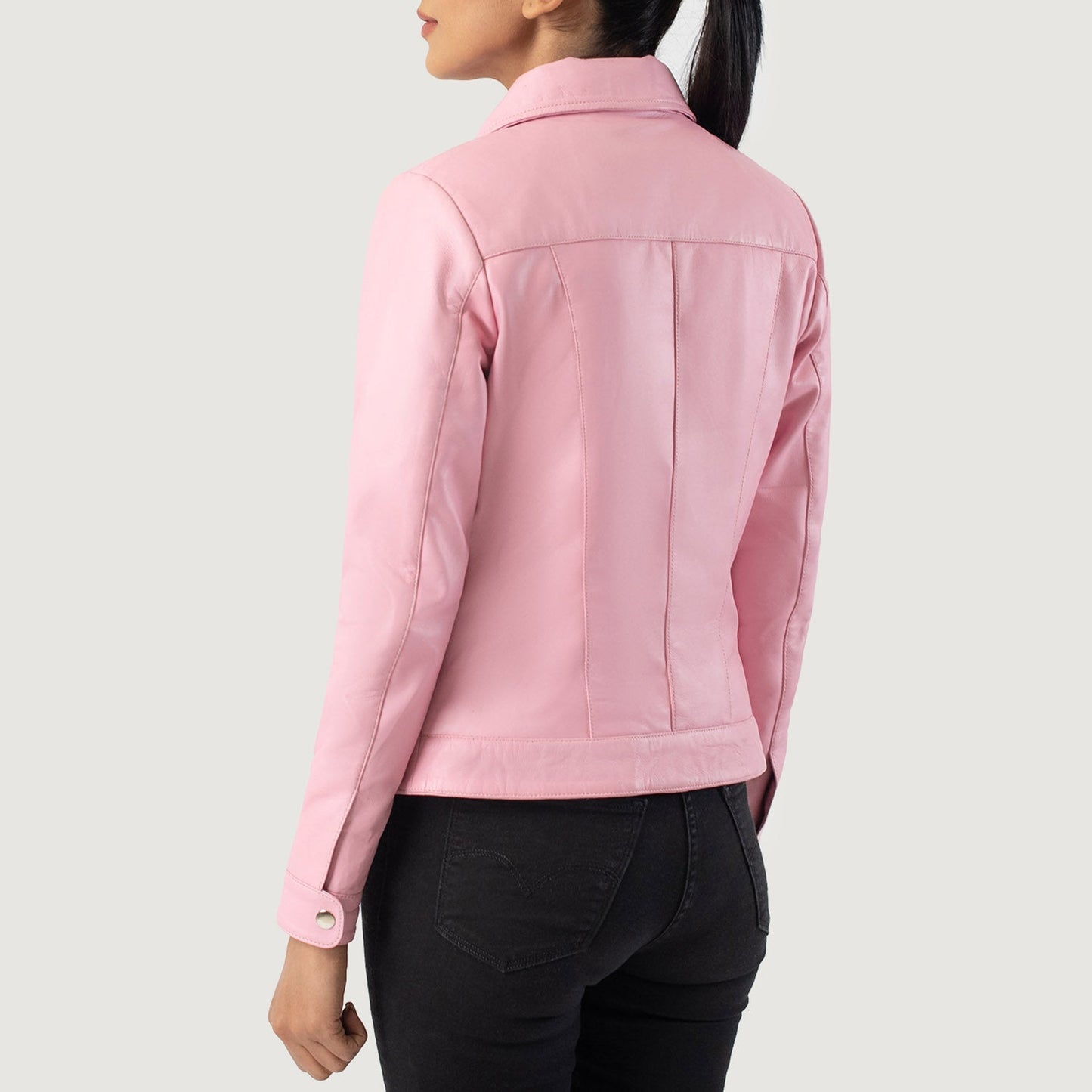 Close up of the sleeve cuffs featuring the premium metallic snap button closures on the pink sheepskin hide.
