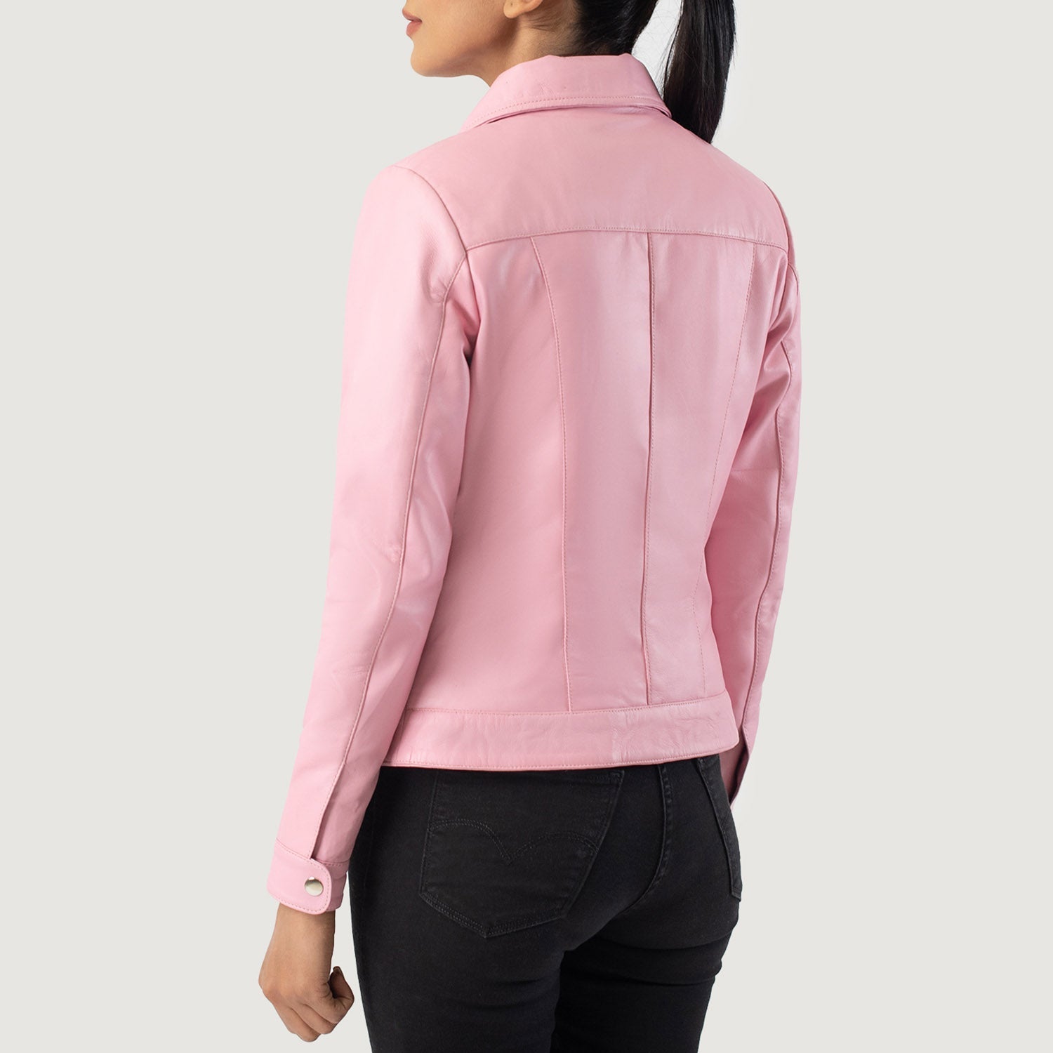 Close up of the sleeve cuffs featuring the premium metallic snap button closures on the pink sheepskin hide.